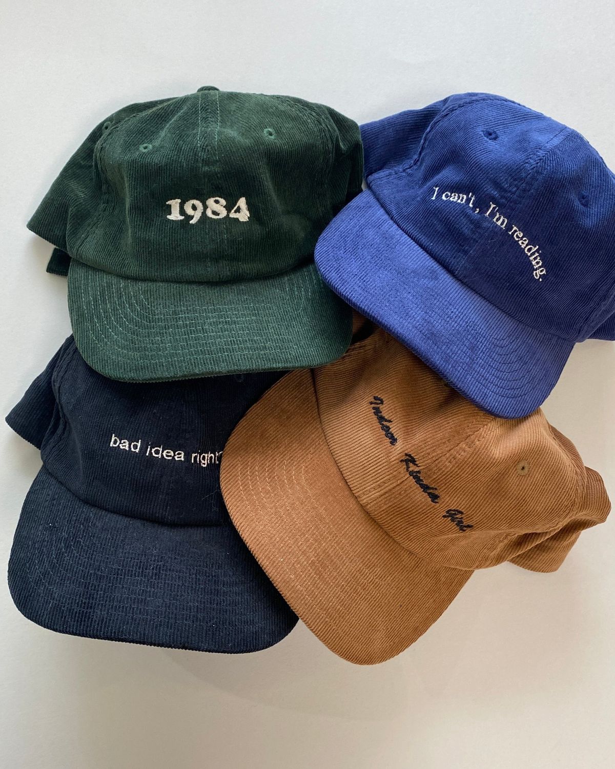 Corduroy caps in green, blue, navy and tan with embroidered lettering